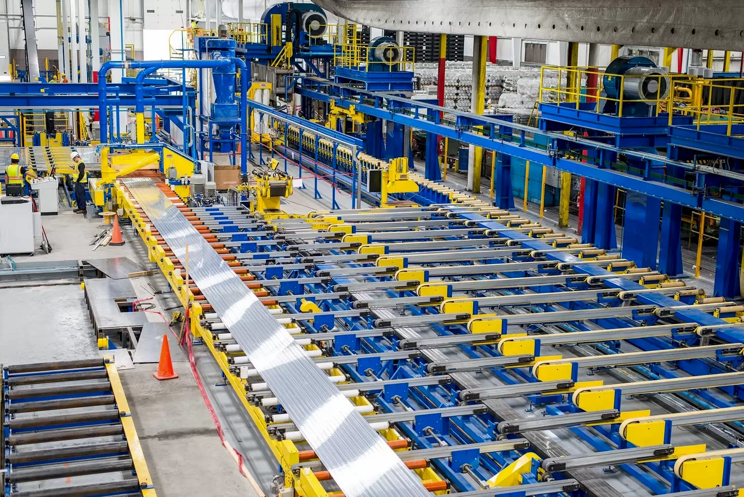 Aluminium extrusion line — freshly extruded profiles on the run-out conveyor